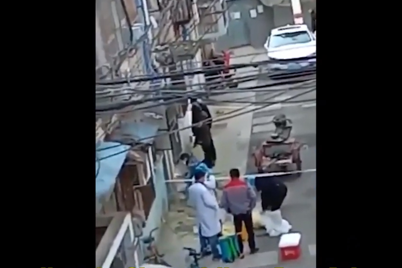 Des agents soudent la porte d'un immeuble résidentiel. Photo - Youtube