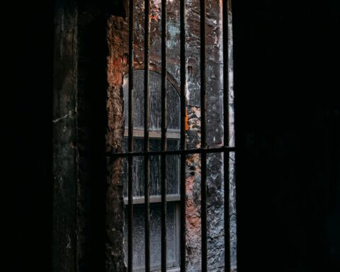 Rusted prison bars casting shadows — Venezuelan political detention
